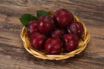Plum heap in the wooden basket