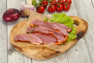 Sliced smoked duck breast served salad
