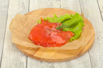 Sliced salmon fillet served rosemary