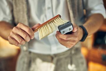 Professional barber keeping his tools clean for every client