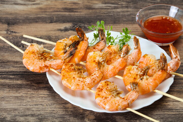 Grilled prawn skewer with sauce