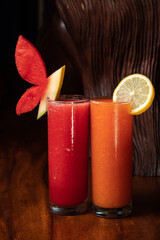 Watermelon and papaya smoothie on wood background. Healthy juice. Detox, diet food, vegetarian food, healthy eating concept. Red orange Vitamin drink diet vegan food concept refreshing fruit beverage
