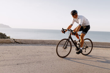 Fototapeta premium Professional road bicycle racer in action on mountain road