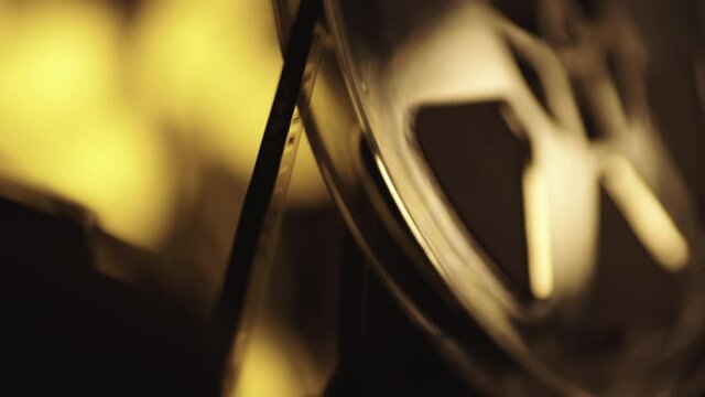 Super 8mm Projector, Golden tone while 8mm film reels through the 400ft spool