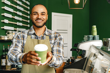 Portrait of a mixed race young man barista in coffee shop