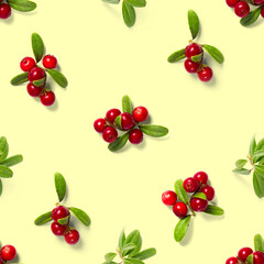 Lingonberry seamless pattern on yellow background. Fresh cowberries or cranberries with leaves as seamless pattern for textile, fabric, print