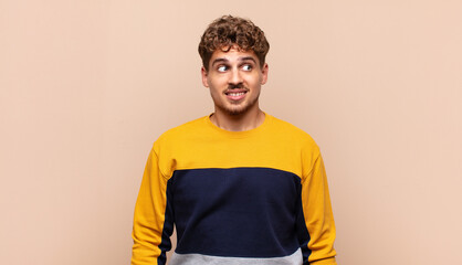 young man looking worried, stressed, anxious and scared, panicking and clenching teeth