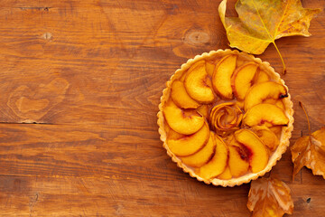 Homemade traditional sweet autumn tart pie on wooden table