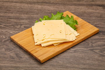Sliced yellow cheese over board
