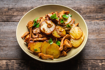 Roasted slices of young potatoes with chanterelle mushrooms. Selective focus. Shallow depth of field. 