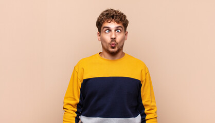 young man looking goofy and funny with a silly cross-eyed expression, joking and fooling around