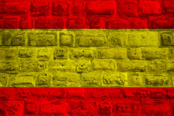 national flag of the modern state of Spain on an old stone wall with cracks, the concept of business, tourism, travel, emigration, globalization