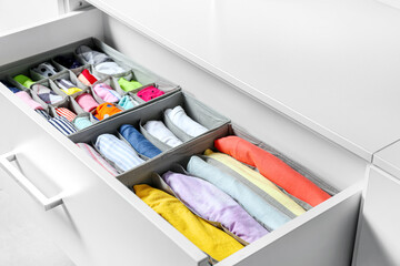 Open drawer with clean clothes in closet