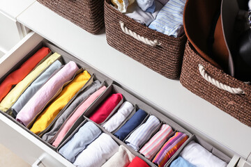 Open drawer with clean clothes in closet