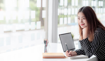 Fototapeta premium Beautiful businesswoman sitting at her desk wite happiness.