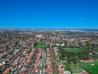 Panoramic Aerial Drone view of Suburban Sydney housing, roof tops, the streets and the parks