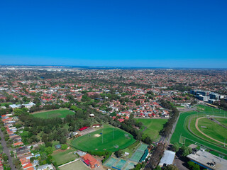 Fototapeta premium Panoramic Aerial Drone view of Suburban Sydney housing, roof tops, the streets and the parks