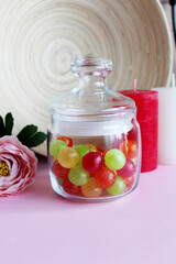 Delicious multi-colored fruit lollipops in a glass jar.