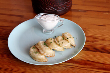 Serving of dumplings with creamy sauce.