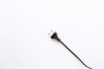 Black flat electrical plug with wire isolated on white background without nothing. The appliance is off. Electricity safety precautions.