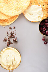 Baking concept on gray background. Cream and cake layers. Space for text.