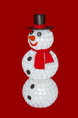 Snowman from plastic cups isolated on the red background with the shadow