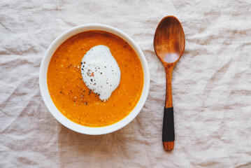 Hot spicy pumpkin soup with heavy cream and pepper.