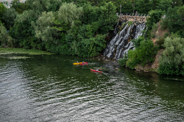 Tourists on kayaks near Roaring Threshold Waterfall on Monastyrsky Island in Dnipro (Ukraine)....