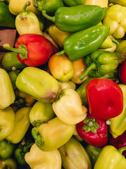 Capsicum annuum (Latin Capsicum annuum) red, yellow and green are piled on top of each other for sale in the supermarket.