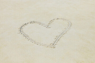 Heart drawn in the sand on Beach background