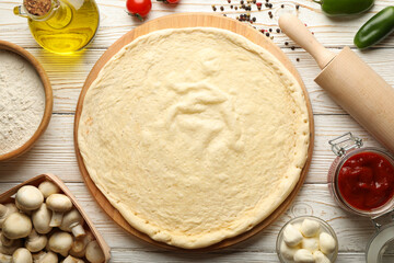Ingredients for cooking pizza on wooden background