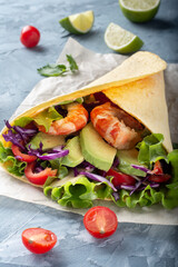 Cheese tortilla with avocado and vegetables. Tortilla with vegetables and shrimp. Tortilla from the sea.