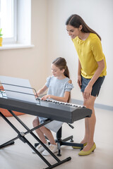 Girl having a private music lesson and looking involved