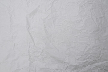 Crumpled white paper background.