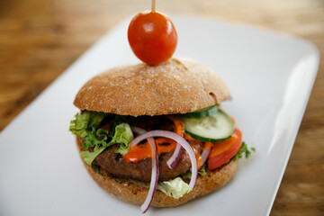 A burger isolated on a white plate with negative space
