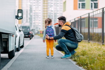 Father and daughter going to school for the first time. Back to school after pandemic.