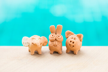 Happy animal clay friend over blurred blue water background, safe animal, cute little elephant with...