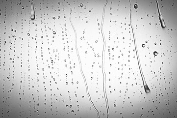 Drops water on the clear glass gray background. Water condensation
