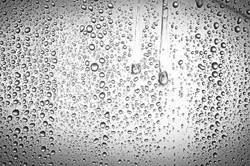 Drops water on the clear glass gray background. Water condensation