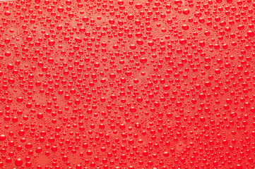 Drops water on the clear glass red background. Water condensation