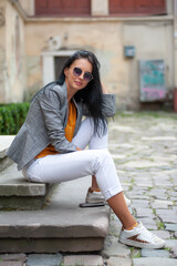 Beautiful young woman in business clothes in the old town