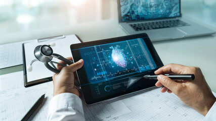Cardiologist doctor with stethoscope. Analysis and touching medical network connection on tablet...