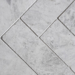 Gray floor tiles, herringbone pattern, close-up