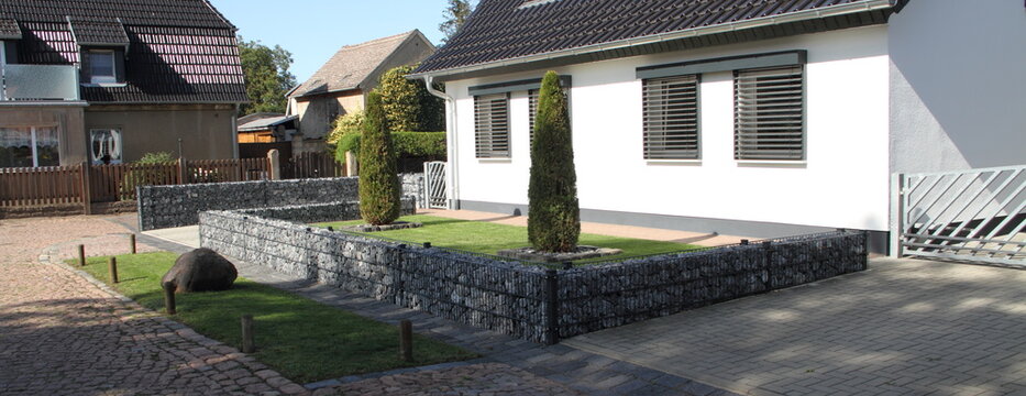 a new house with gabions as a fence