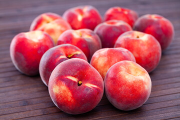 Naklejka na ściany i meble Image of sweet juicy peaches fruit on wooden surface close up