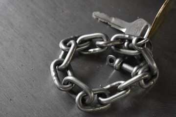 key with metal chain on metal board