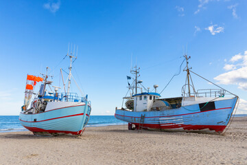 Fototapeta na wymiar Fishing boats on the beach of Thorup Strand on the Danish North Sea coast