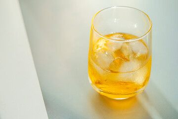 Yellow beverage,cocktale, lemonade  on white background with reflection.