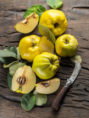 Ripe golden yellow quince fruits on wood. Organic fruits on old table. Top view.
