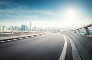 Highway overpass motion blur effect with modern city background